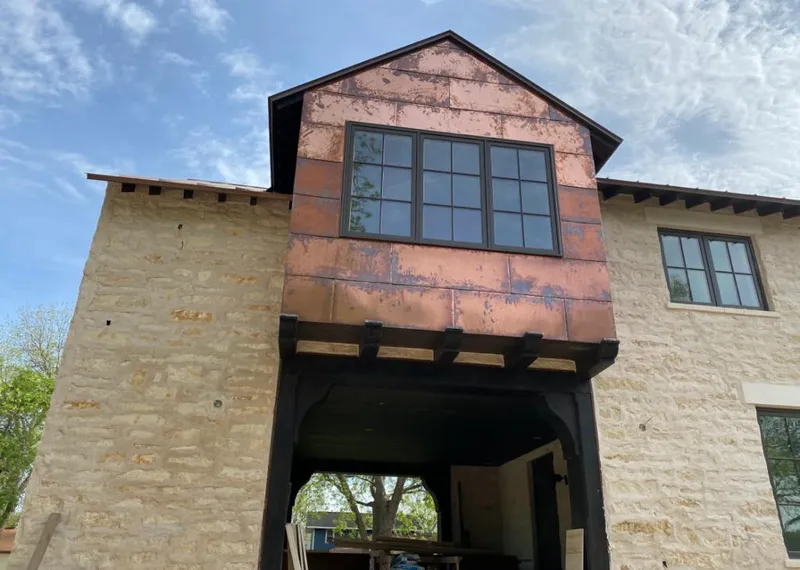 Copper metal panel facade on a stone building for Skylight Installation in Douglasville