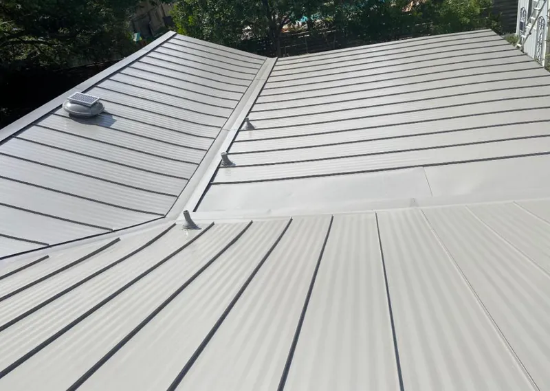 Solar attic fan installed on a metal roof for Roof Ventilation in Douglasville