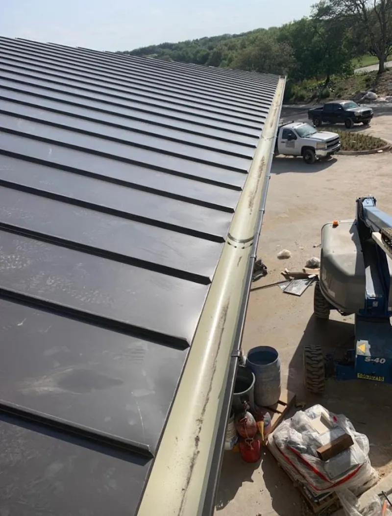 Standing seam panel and gutter detail on a metal roofing jobsite in Douglasville